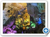 Colourfully illuminated stalactite cave